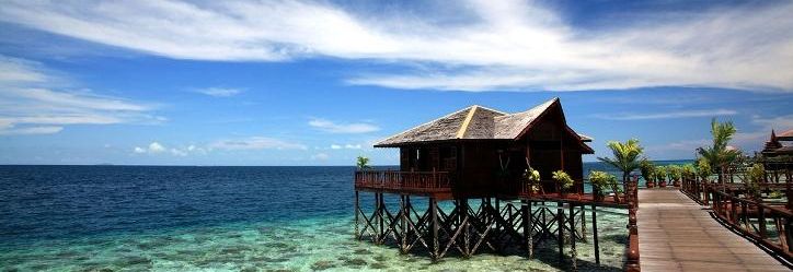Stilt cottage beside the sea and wooden walkway at Sipadan Water Village