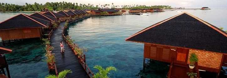 Curving wooden walkway beside the water chalets at Sipadan Water Village
